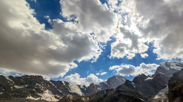 clouds moving over mountains